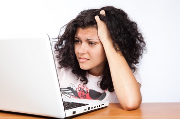 Confused and frustrated woman on computer